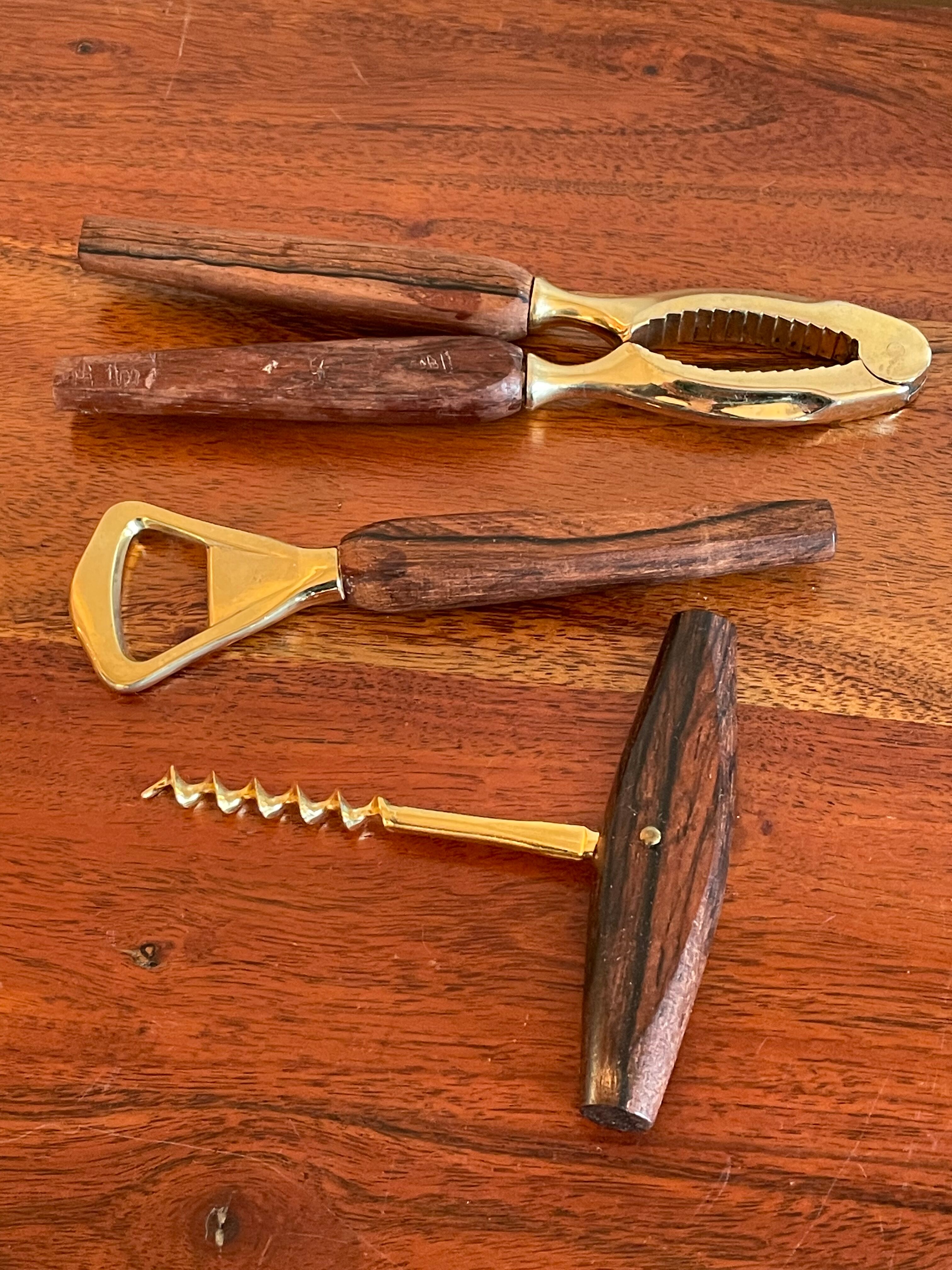Bottle opener made of teak wood, corkscrew and nutcracker