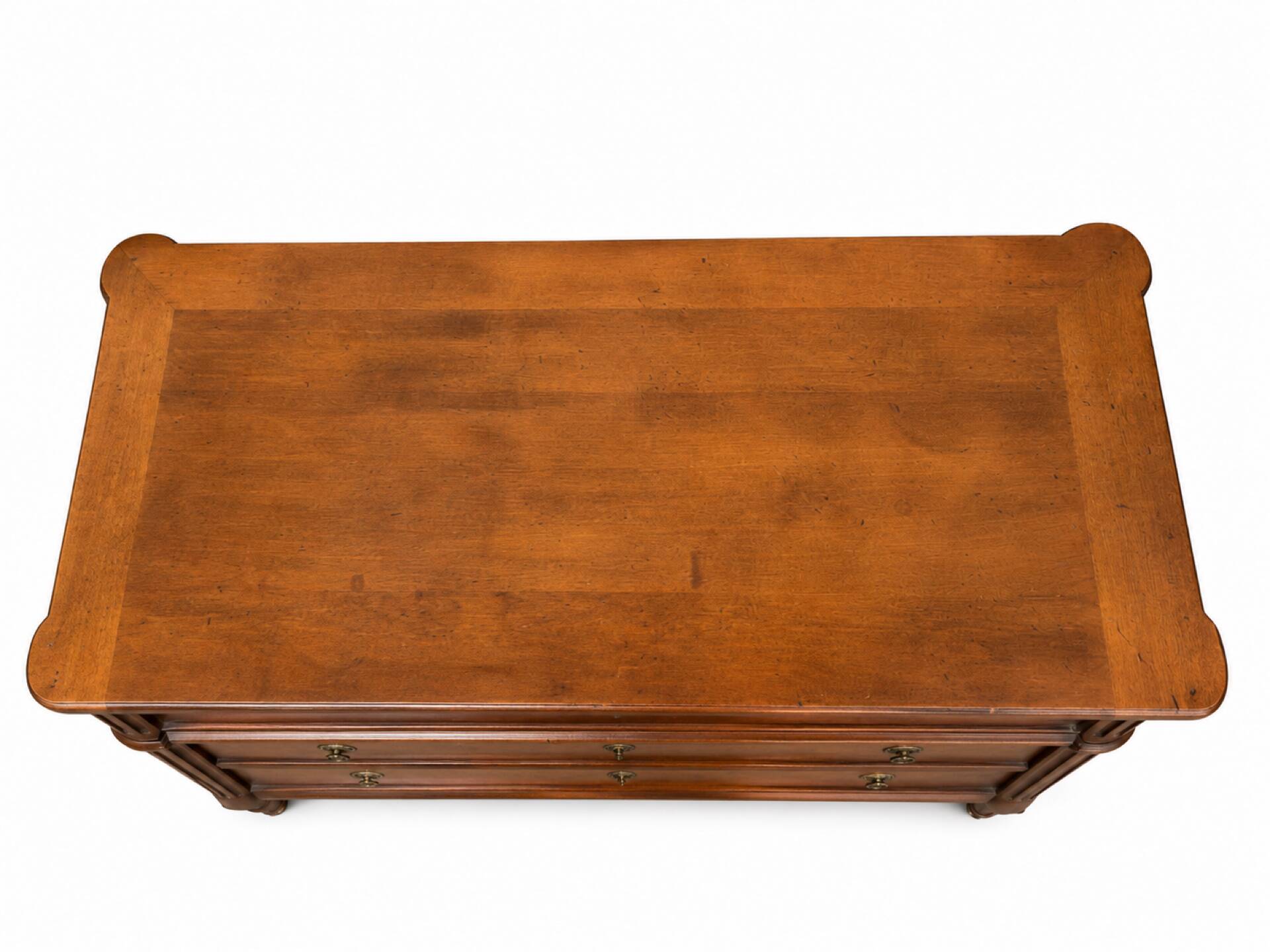 Light walnut commode in Louis XVI style with fluted motifs and three drawers.