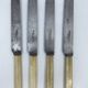 Set of 4 dessert knives with rounded blades and smooth ivory resin handles.