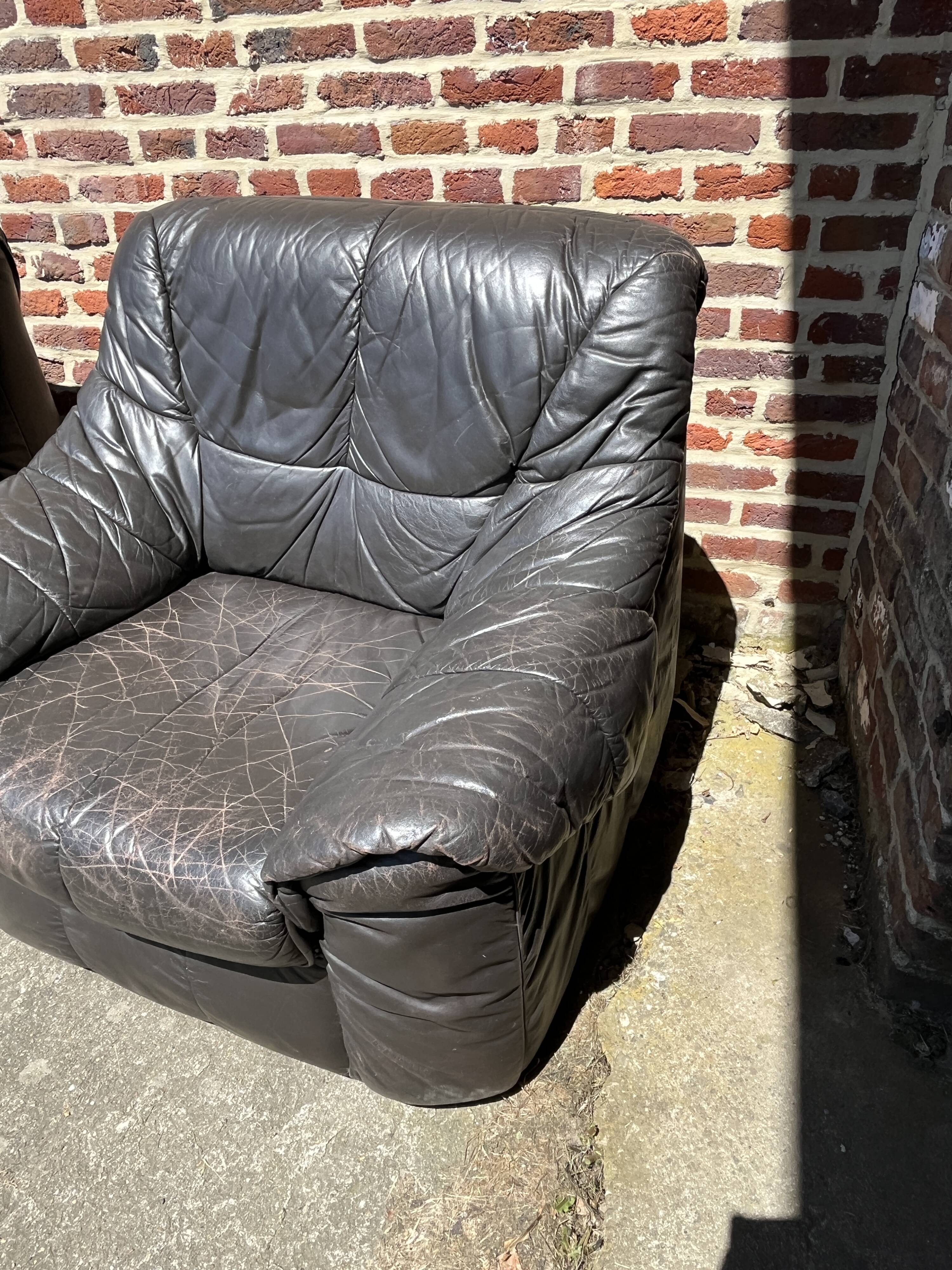Pair of patinated leather club armchairs