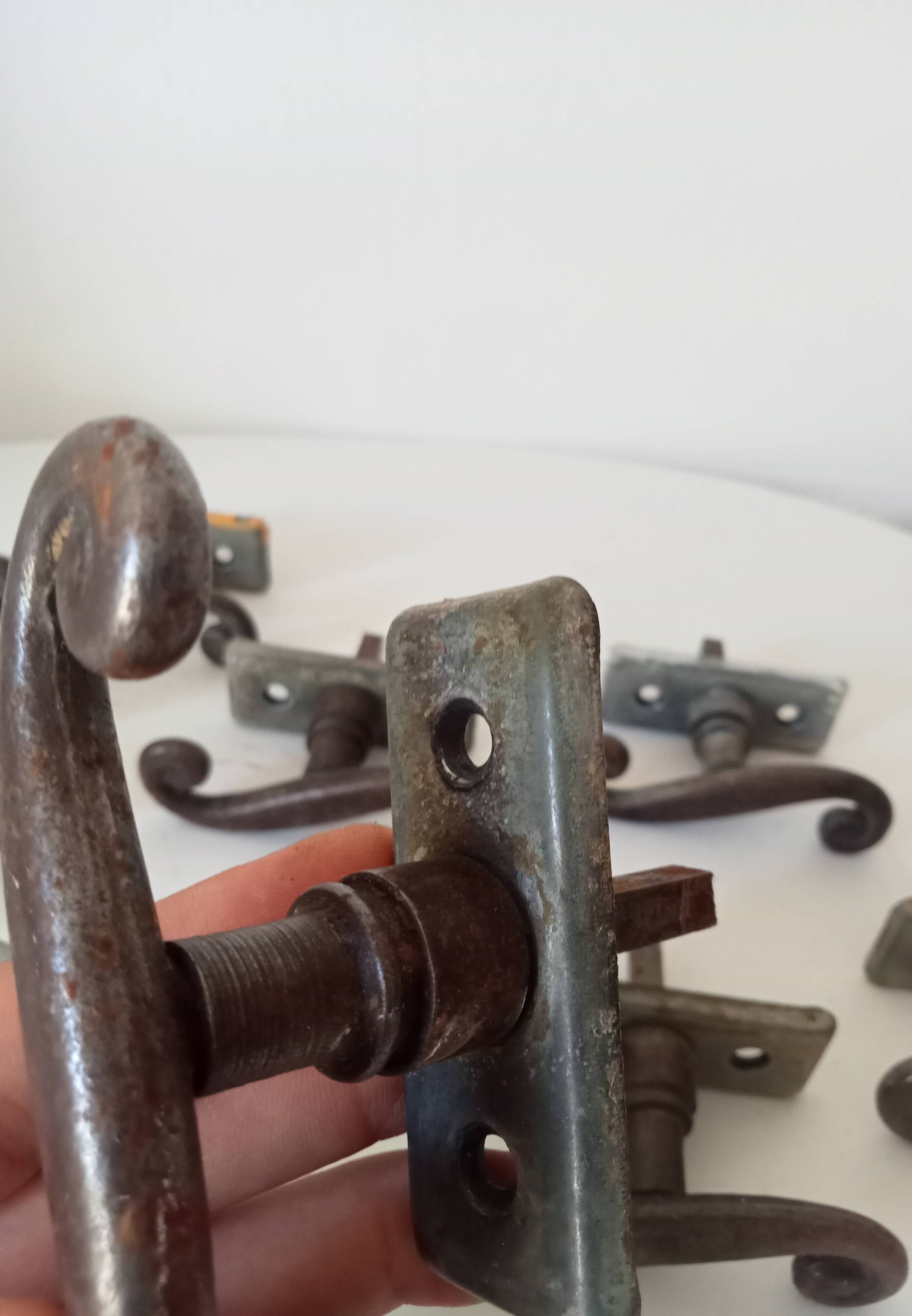 Old window handle with a forged iron cremon.
