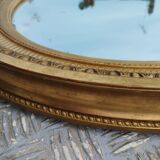 Antique oval mirror in gilded stucco with gold leaf, 19th century