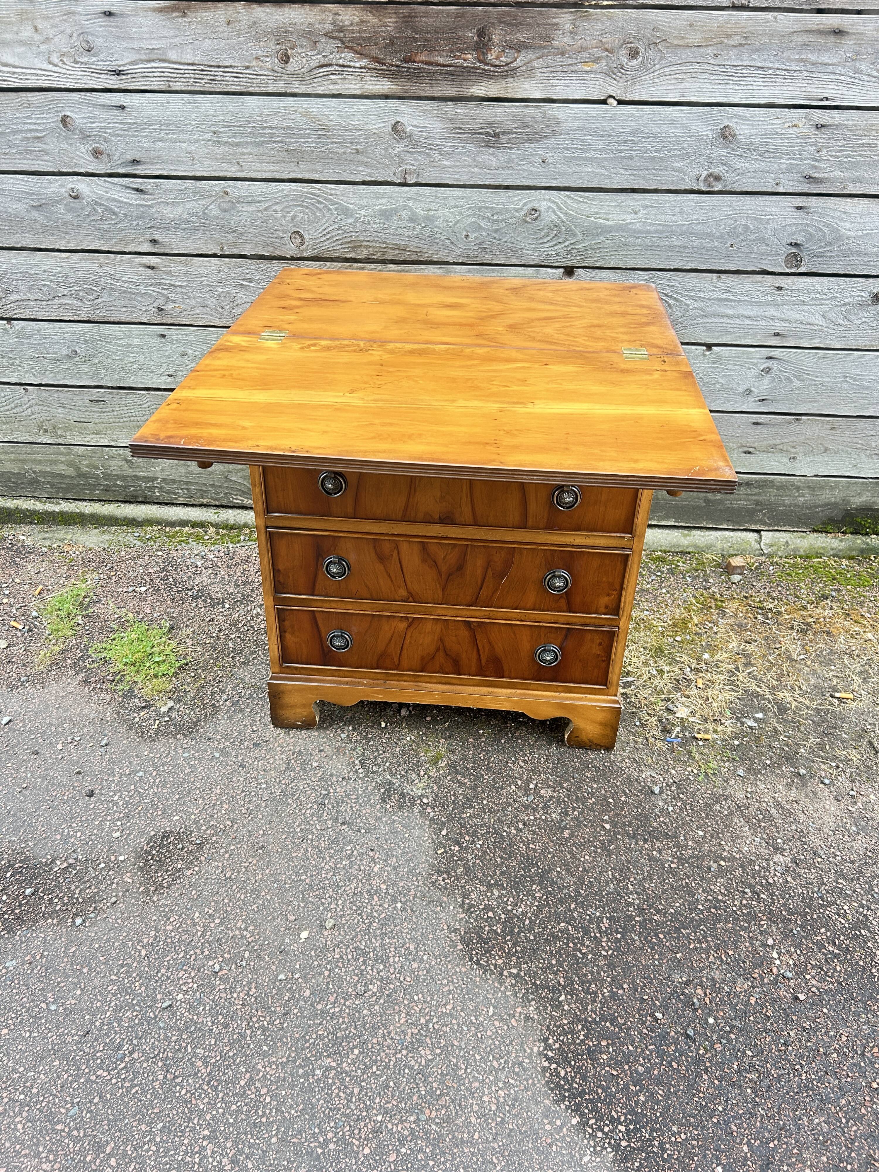 Small English chest of drawers with a folding top.