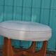 Mid-century ottoman in teak and off-white leather by Kofod Larsen for G-Plan, 1960s.