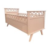 Vintage wooden baby bed in old pink