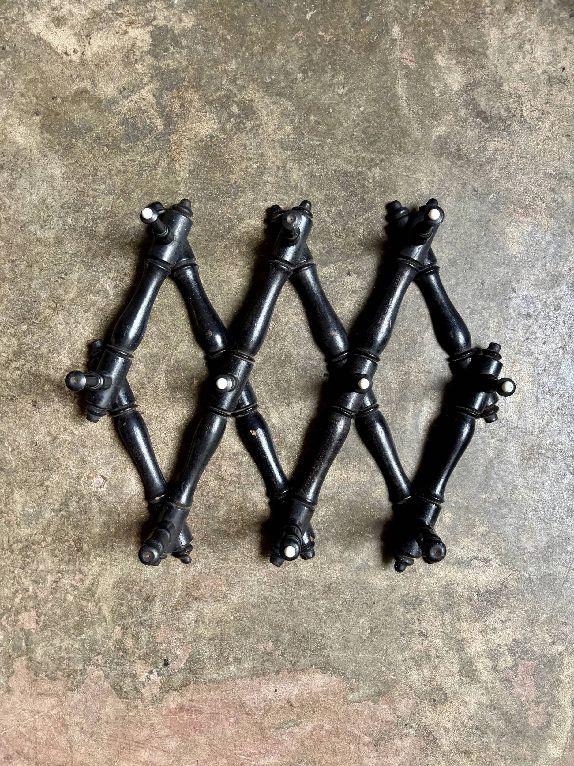 Napoleon III hinged wall-mounted coat rack in black wood