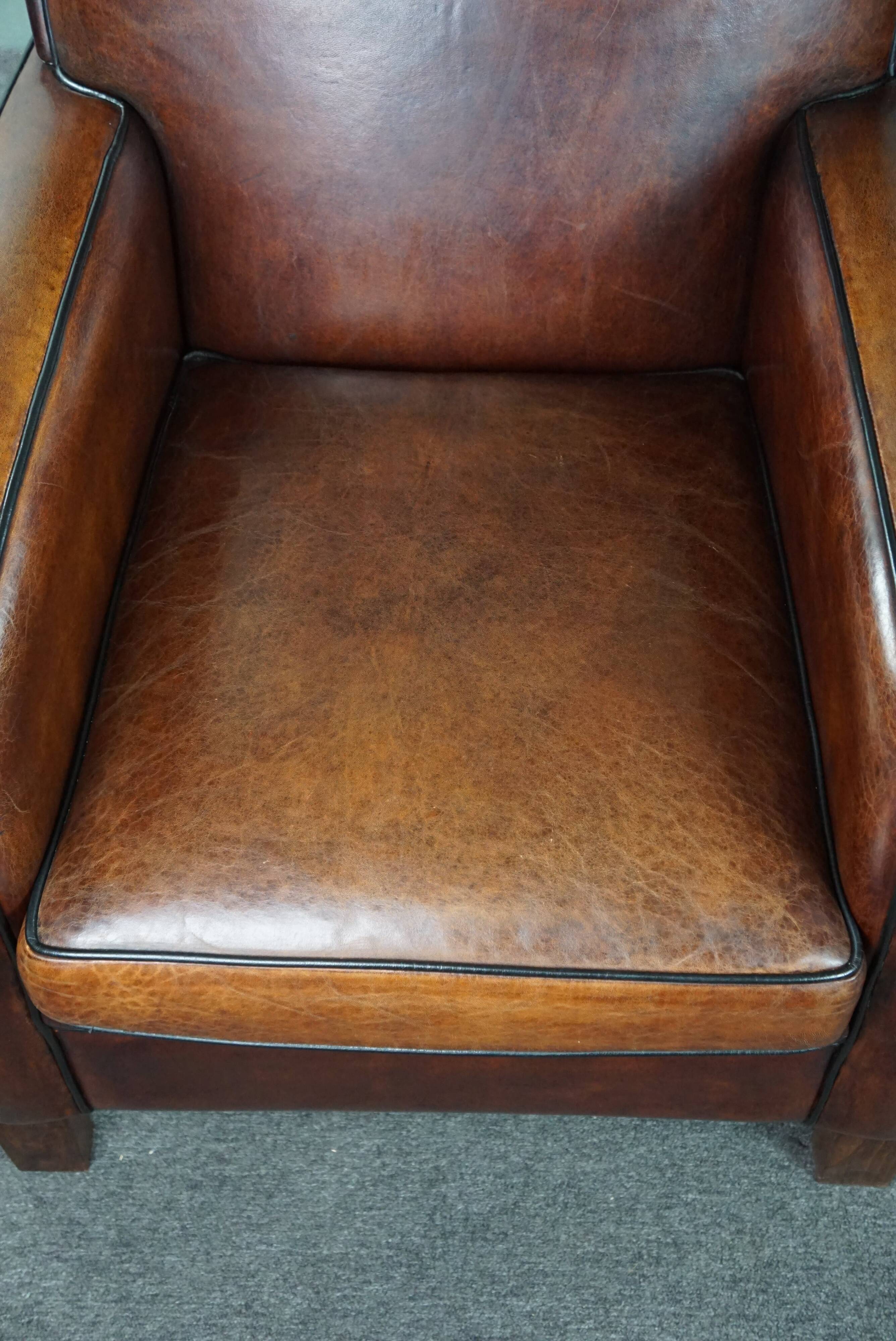 A very beautiful set of 2 Art Deco design armchairs in sheep leather