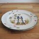 Old hand-painted ceramic plate: 2 birds on a fence.