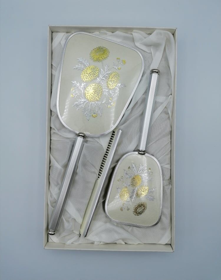 Hand mirror assembly, comb and brush.