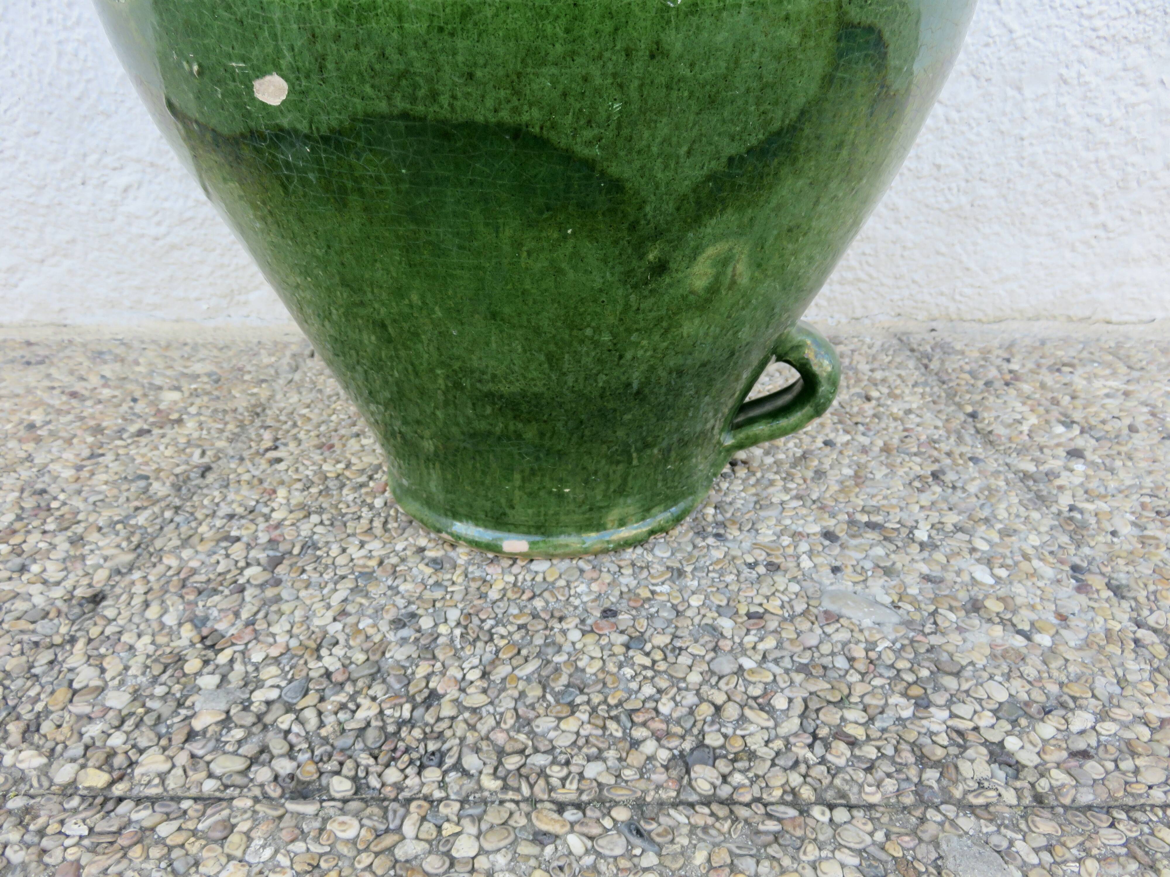 Antique glazed green terracotta oil jar, late 19th century.