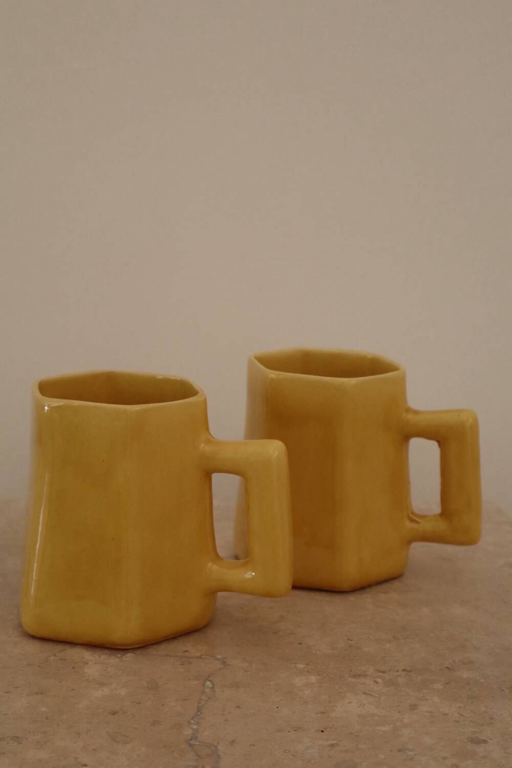 Set of two designer lemon yellow ceramic mugs