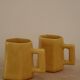 Set of two designer lemon yellow ceramic mugs