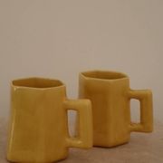 Set of two designer lemon yellow ceramic mugs