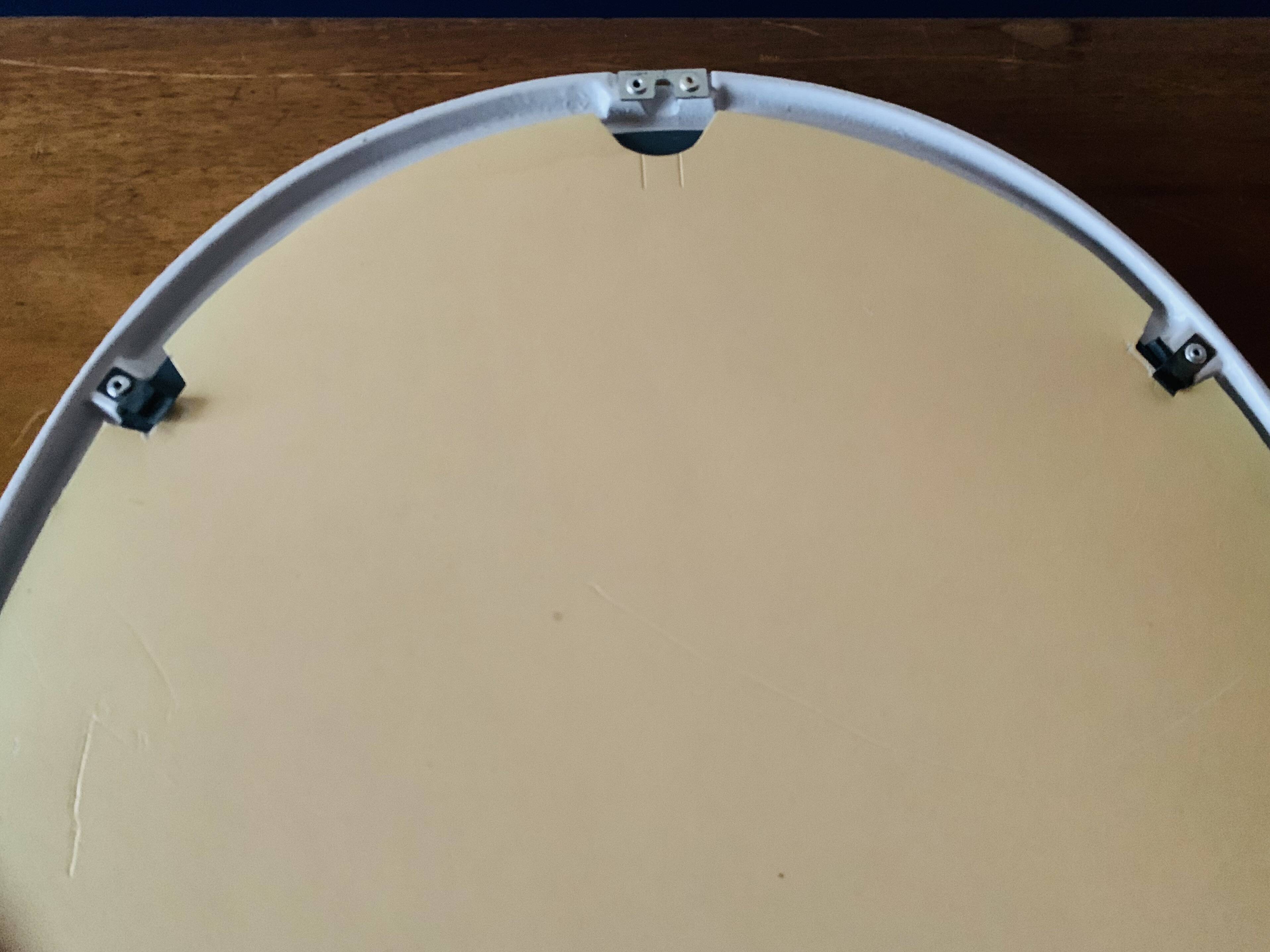 Oval mirror in vintage enameled white cast iron