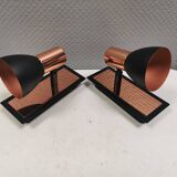 A pair of wall lamps from Eglo, in copper color and black.