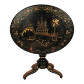 Large tilting pedestal table, black lacquered wood with a lively oriental landscape decoration.