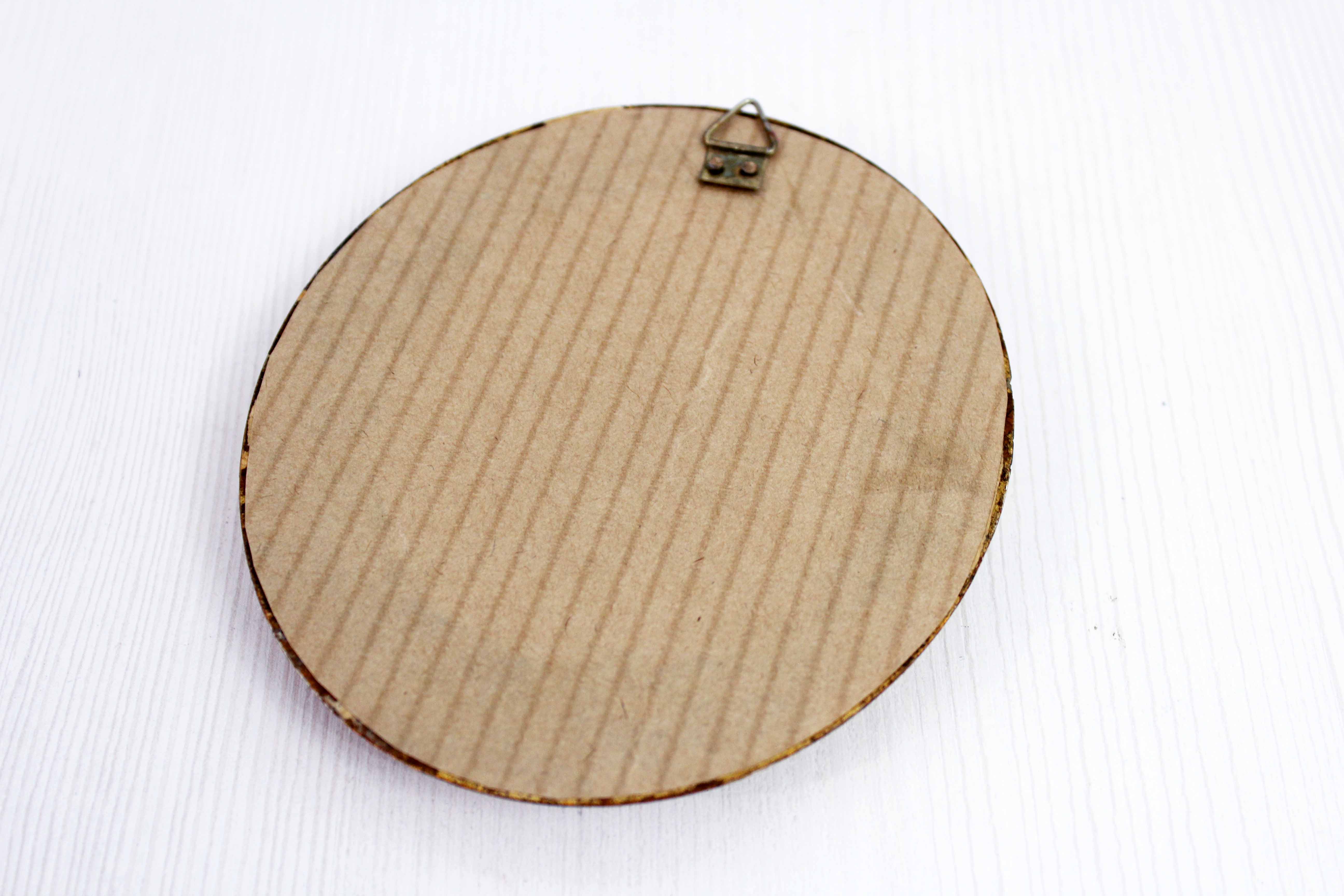 Golden oval mirror