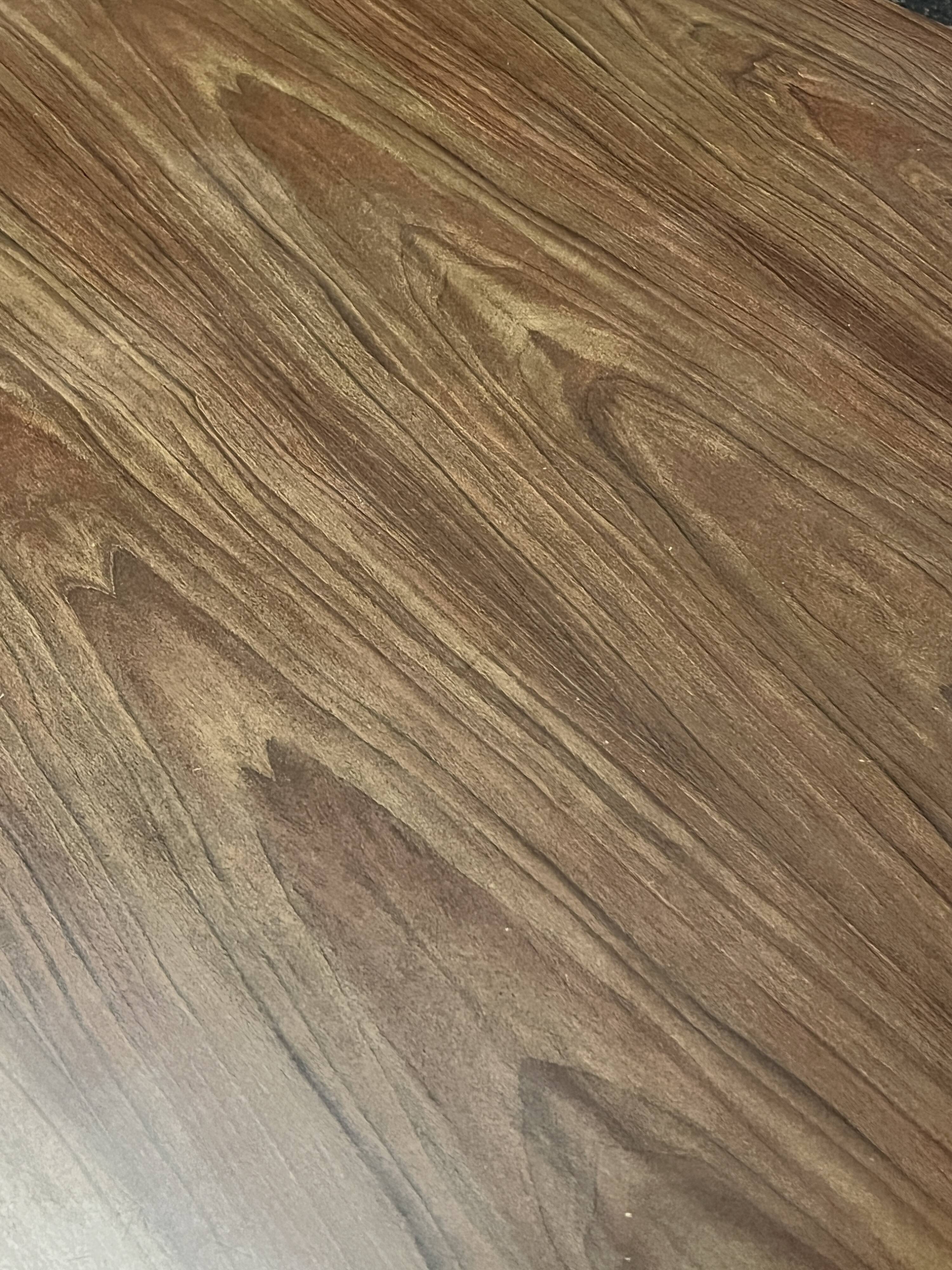 Mid-century round tulip dining table with a wooden top, vintage 1970s design.