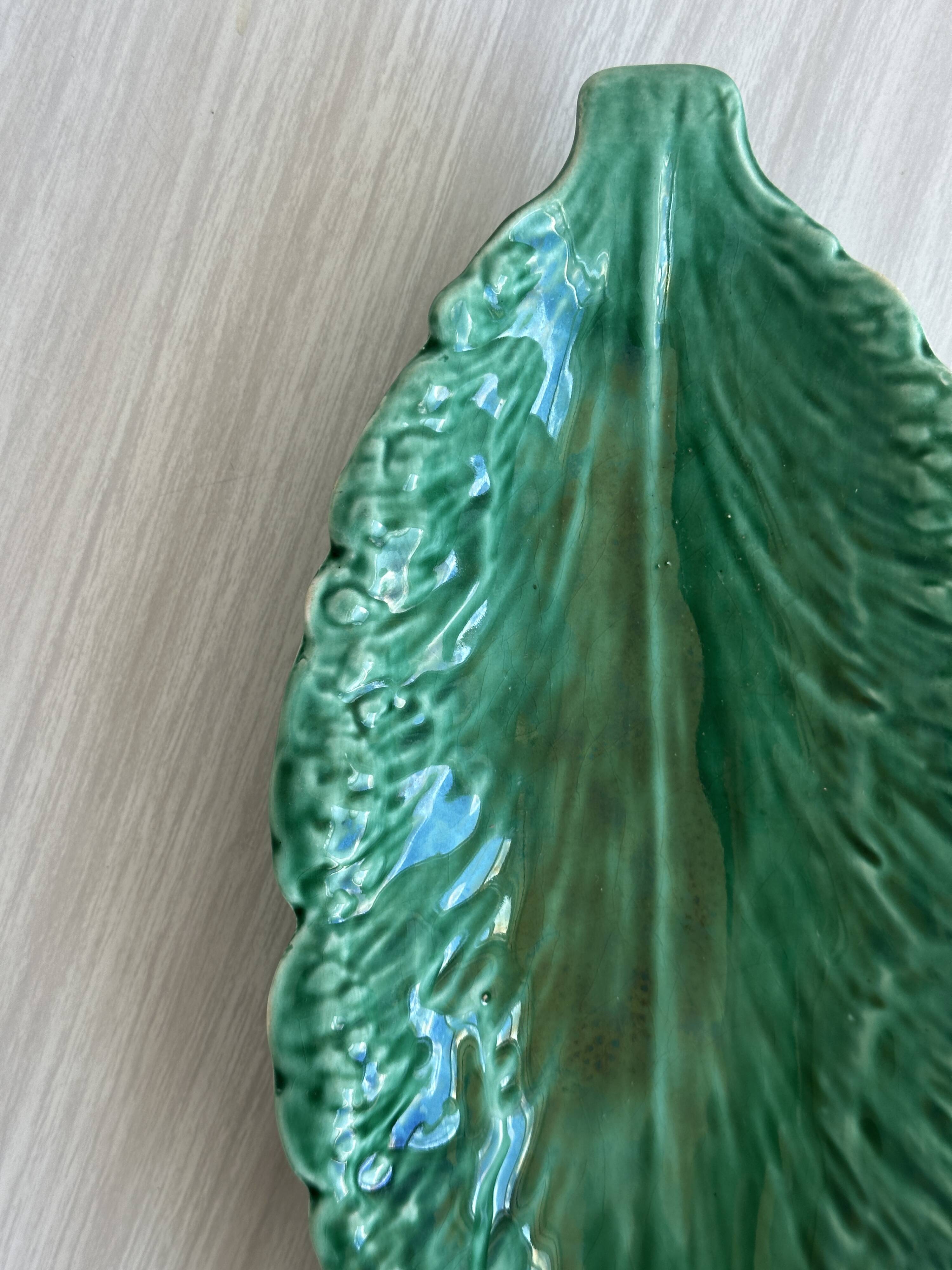 Green earthenware dish in the shape of a leaf