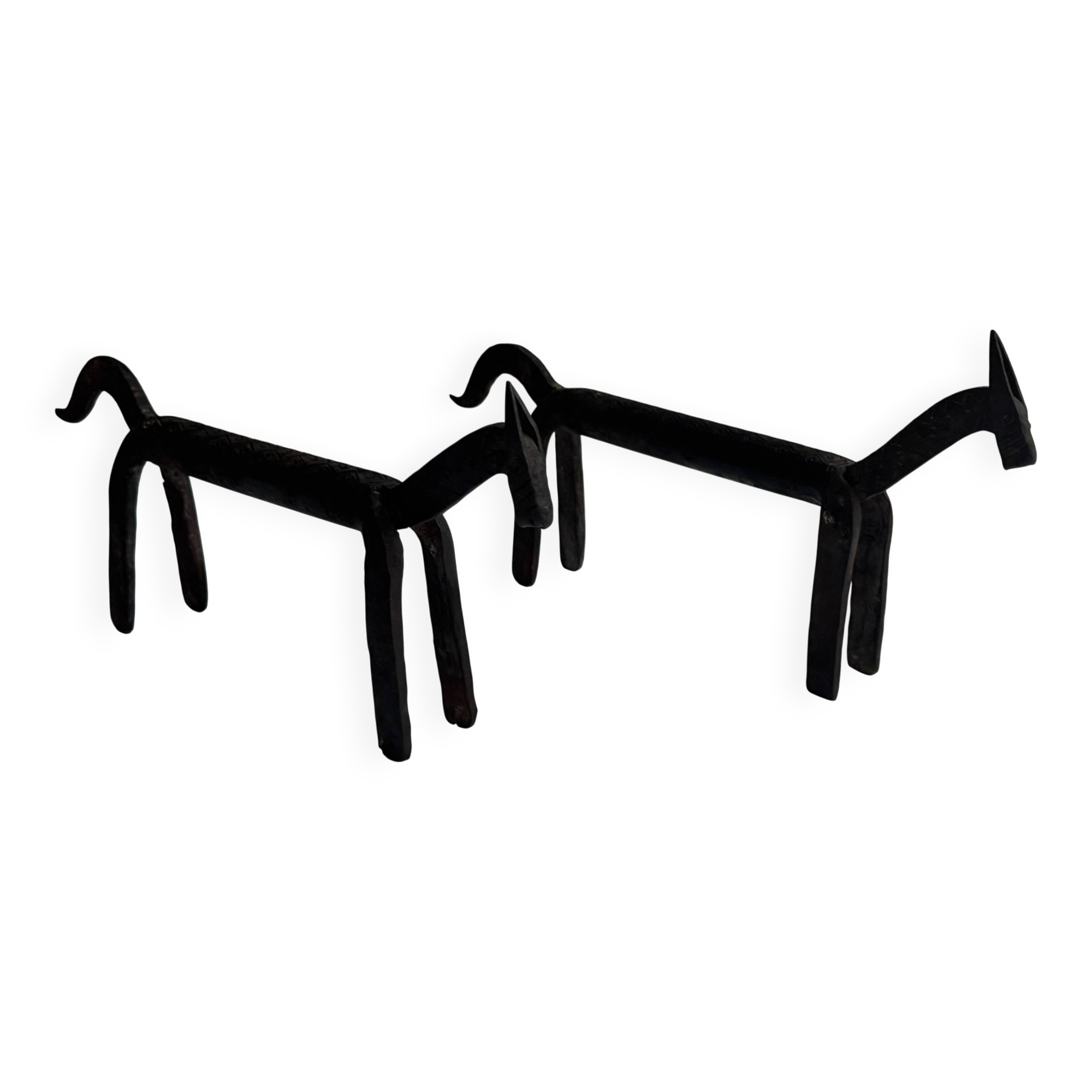 Pair of animal-shaped wrought iron and hammered fire dogs in primitive brutalist style.