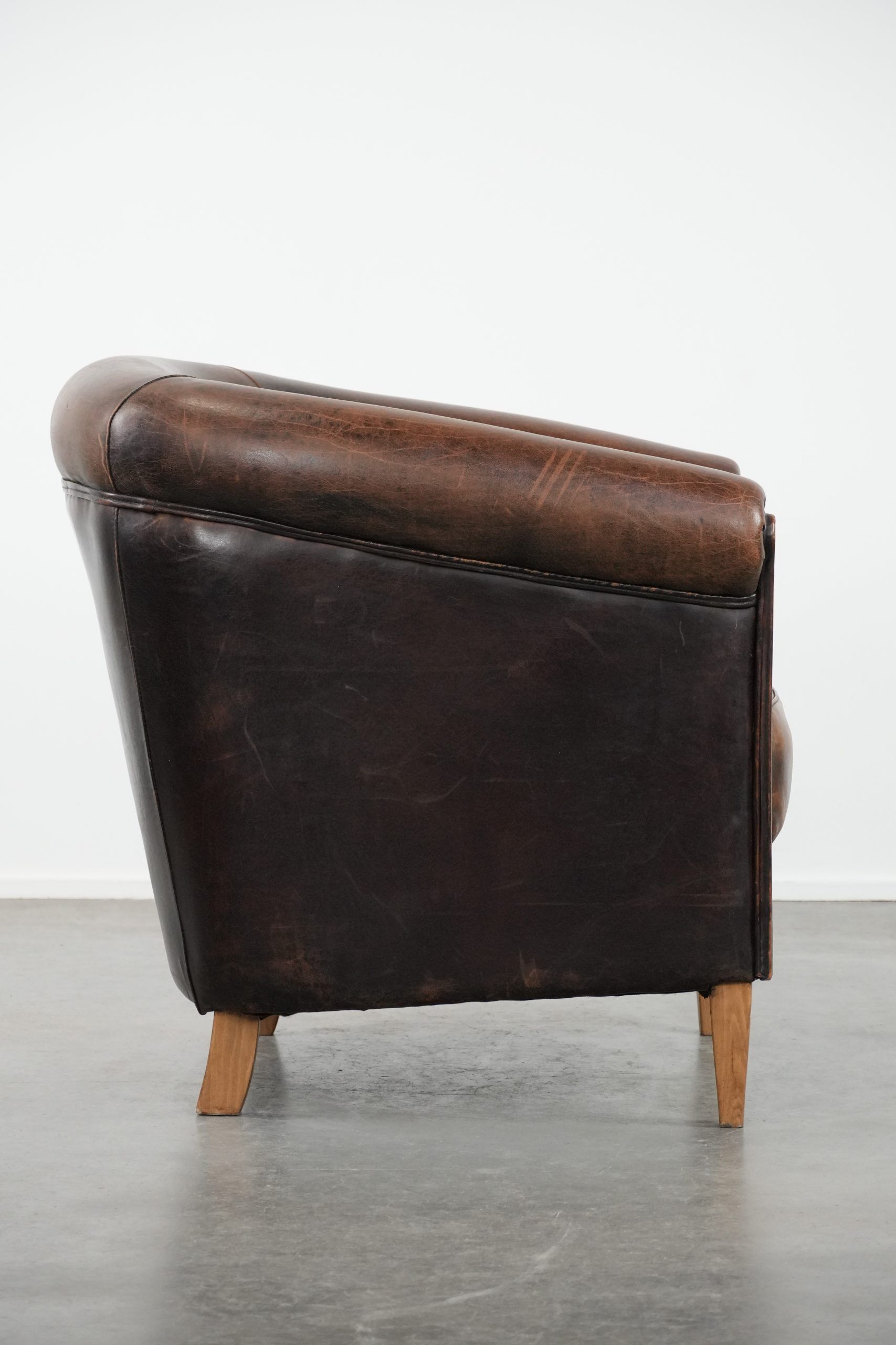 Characterful club armchair made of sheepskin with a beautiful patina