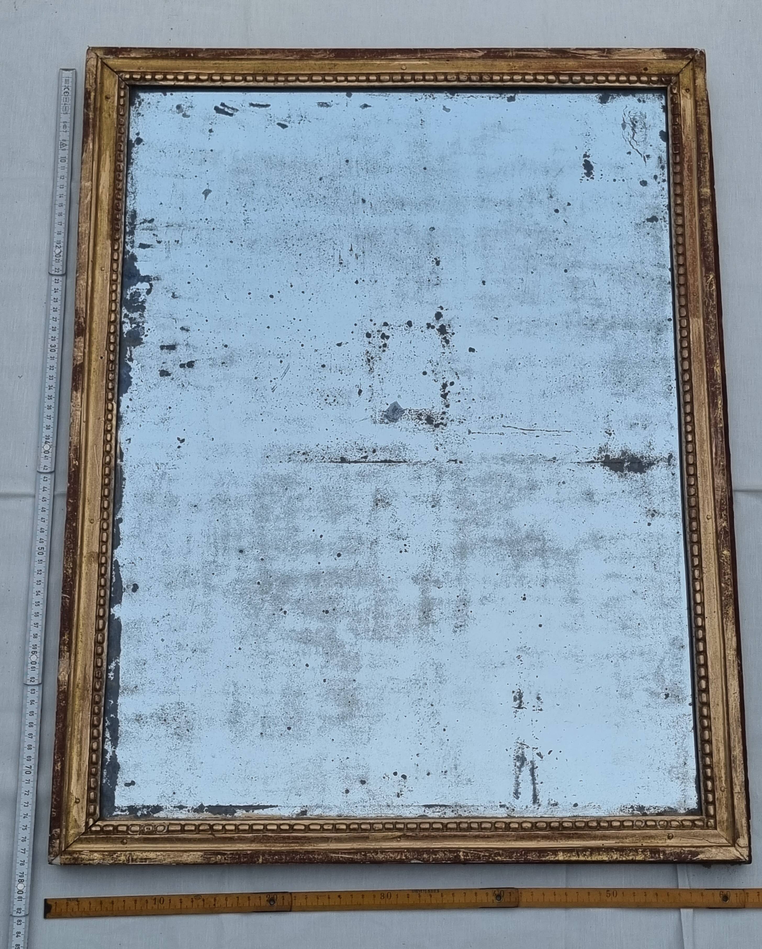 Antique mirror in a gilded wooden frame in the Louis XVI style, 19th century, 62x78 cm.