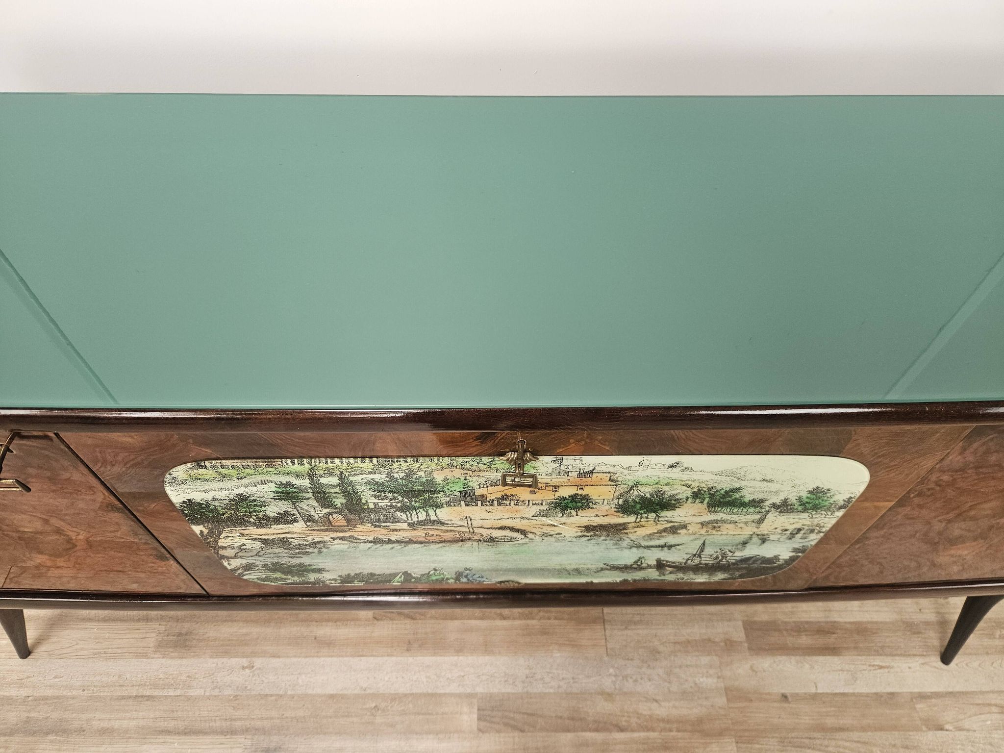 1950s mahogany sideboard with a glass top and central bar.