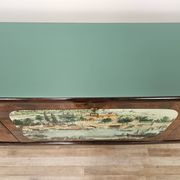 1950s mahogany sideboard with a glass top and central bar.