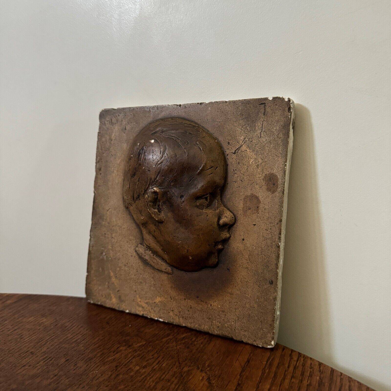 Workshop plaster medallion by Ch. Filleul, head of a young child, 20th century