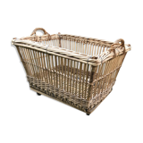 Rattan laundry basket on vintage wheels