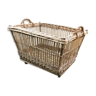 Rattan laundry basket on vintage wheels