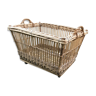 Rattan laundry basket on vintage wheels