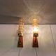 A set of Danish wall lights in champagne coloured glass with brass and teak.