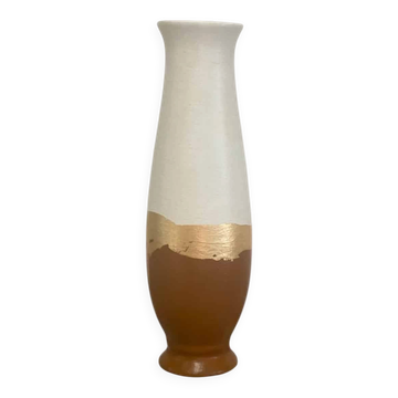 Small decorative terracotta and white vase with a gold leaf trim.