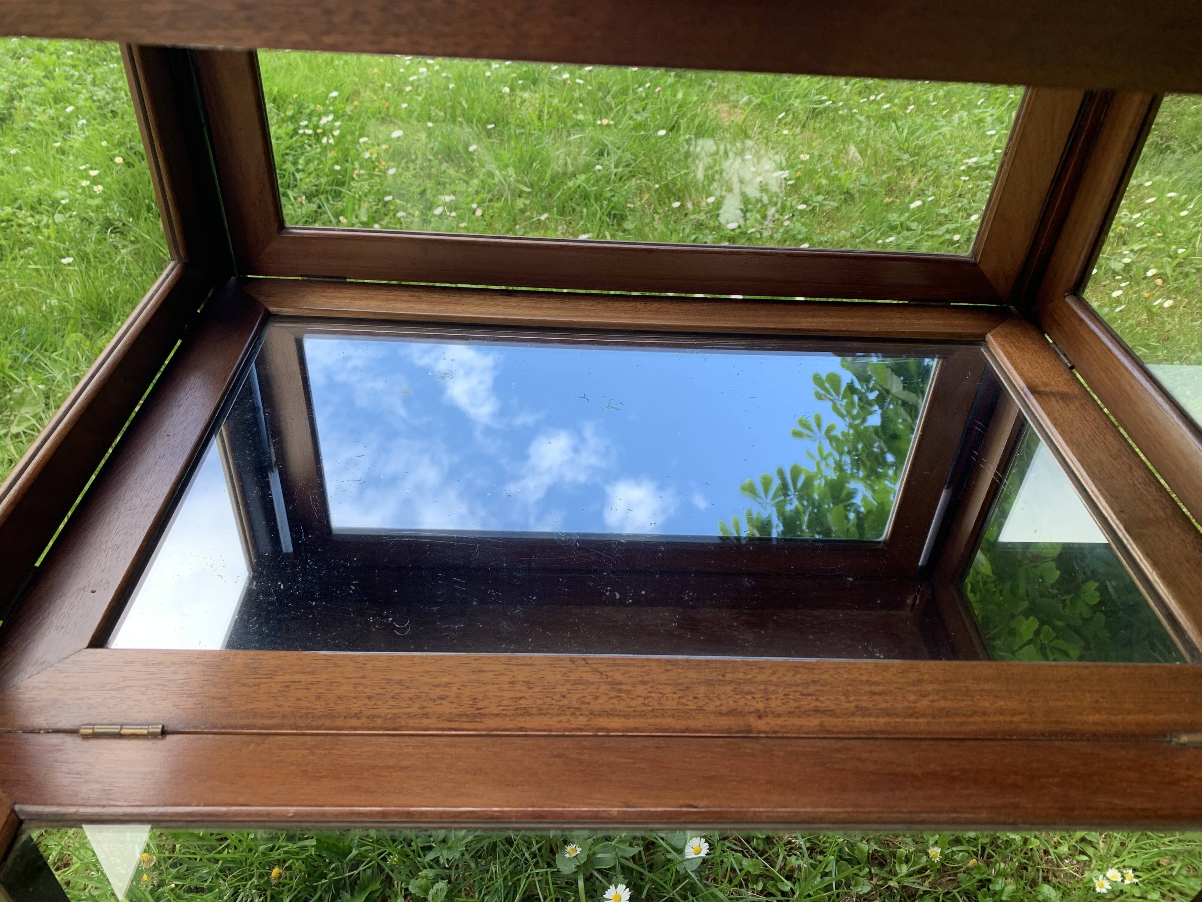 Glass-enclosed old tea table with wooden tray, bronze and brass
