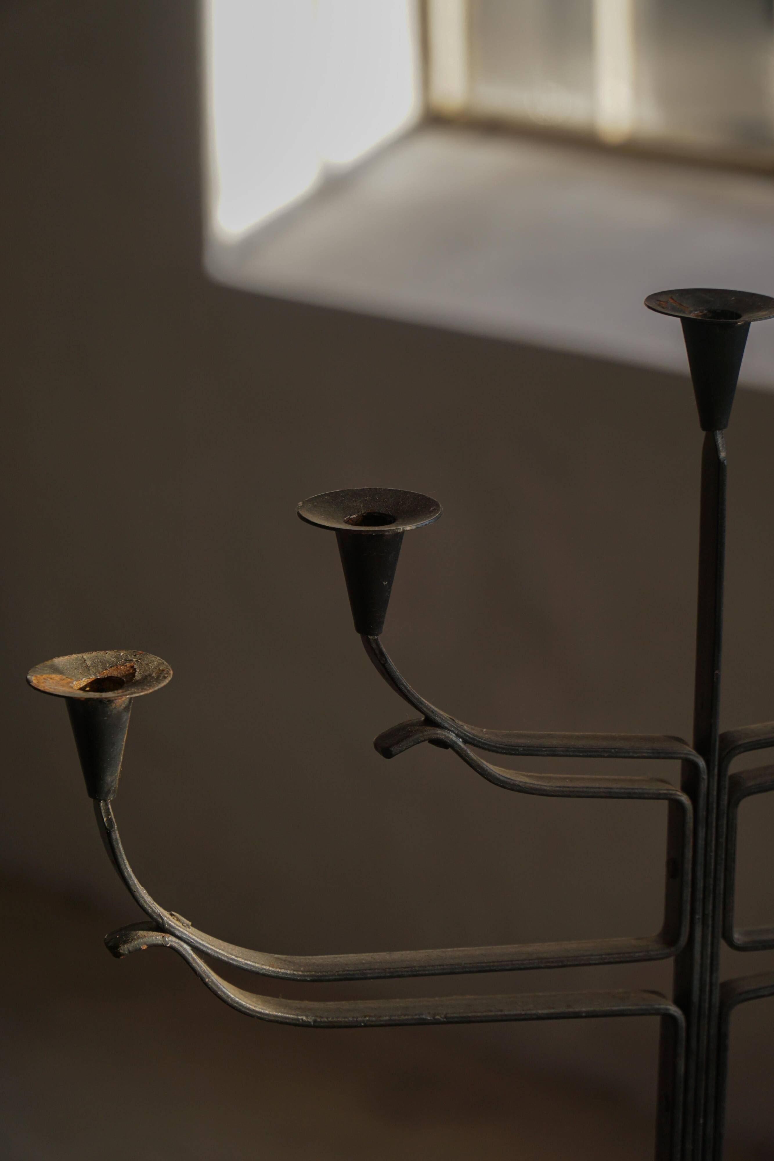 Brutalist Scandinavian candlestick in wrought iron and metal from the mid-20th century.