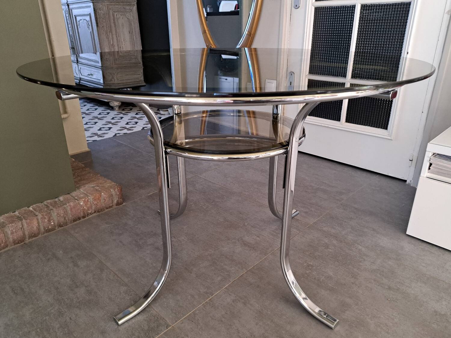 Round table in chromed metal and smoked glass
