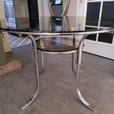 Round table in chromed metal and smoked glass