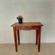 Small antique solid wood table in chic country style with a drawer.