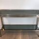 Beautiful console table in brushed metal with bluish glass shelves