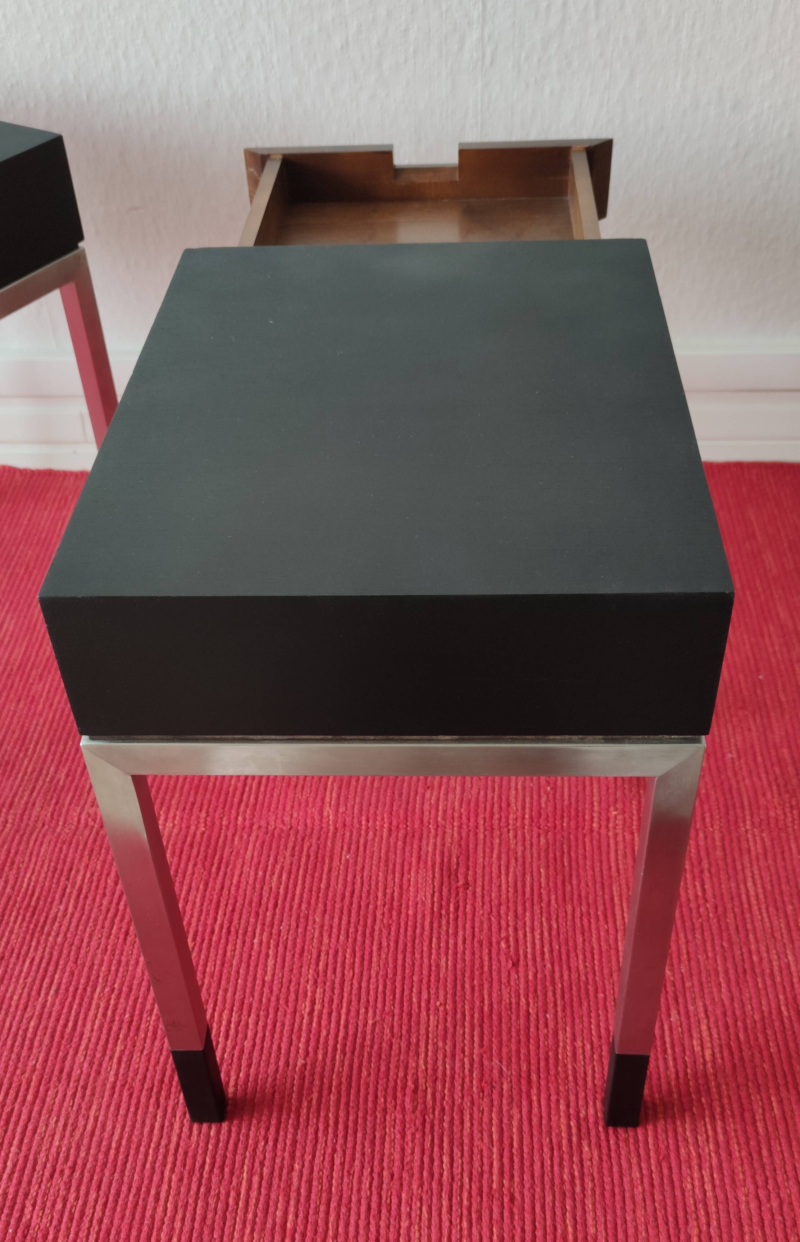 A pair of minimalist bedside tables