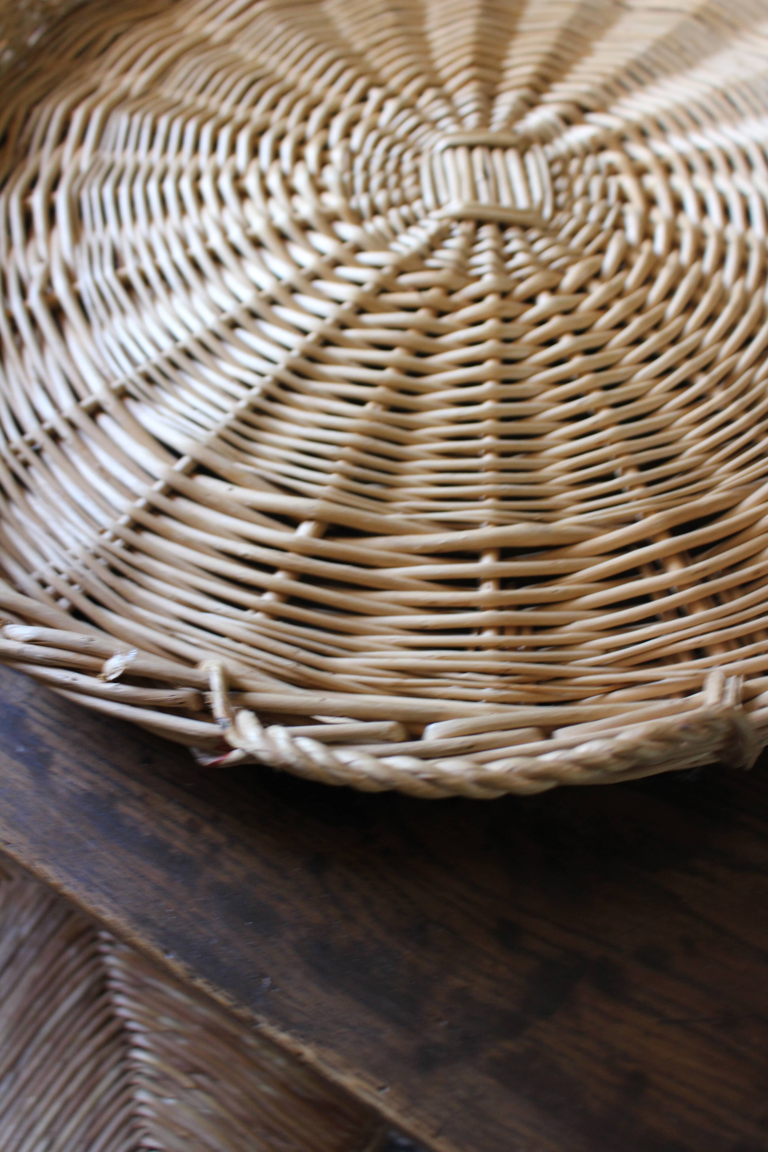 Large round wicker tray with two handles, vintage weaving.