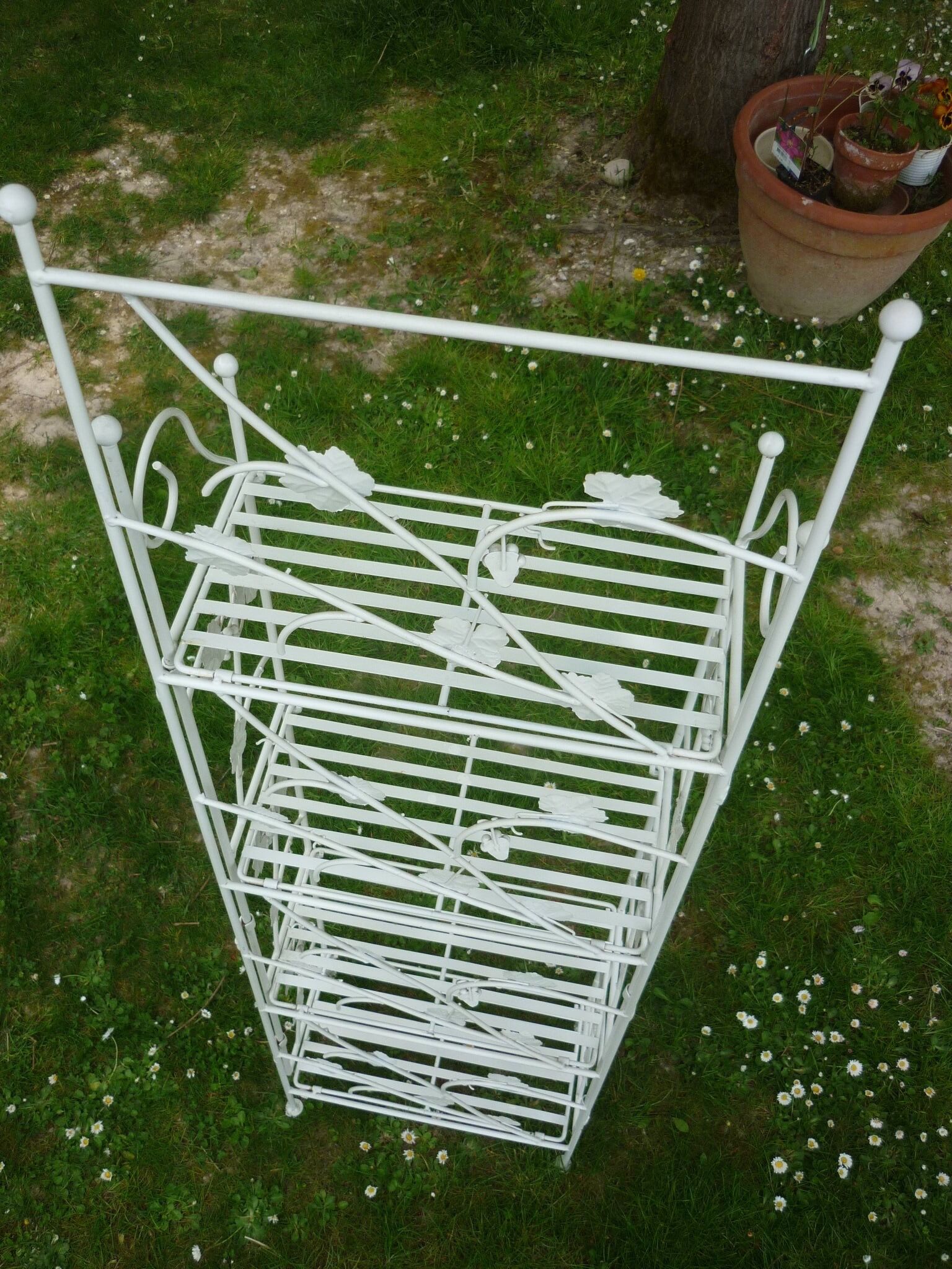 Folding white wrought iron shelf