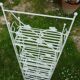 Folding white wrought iron shelf