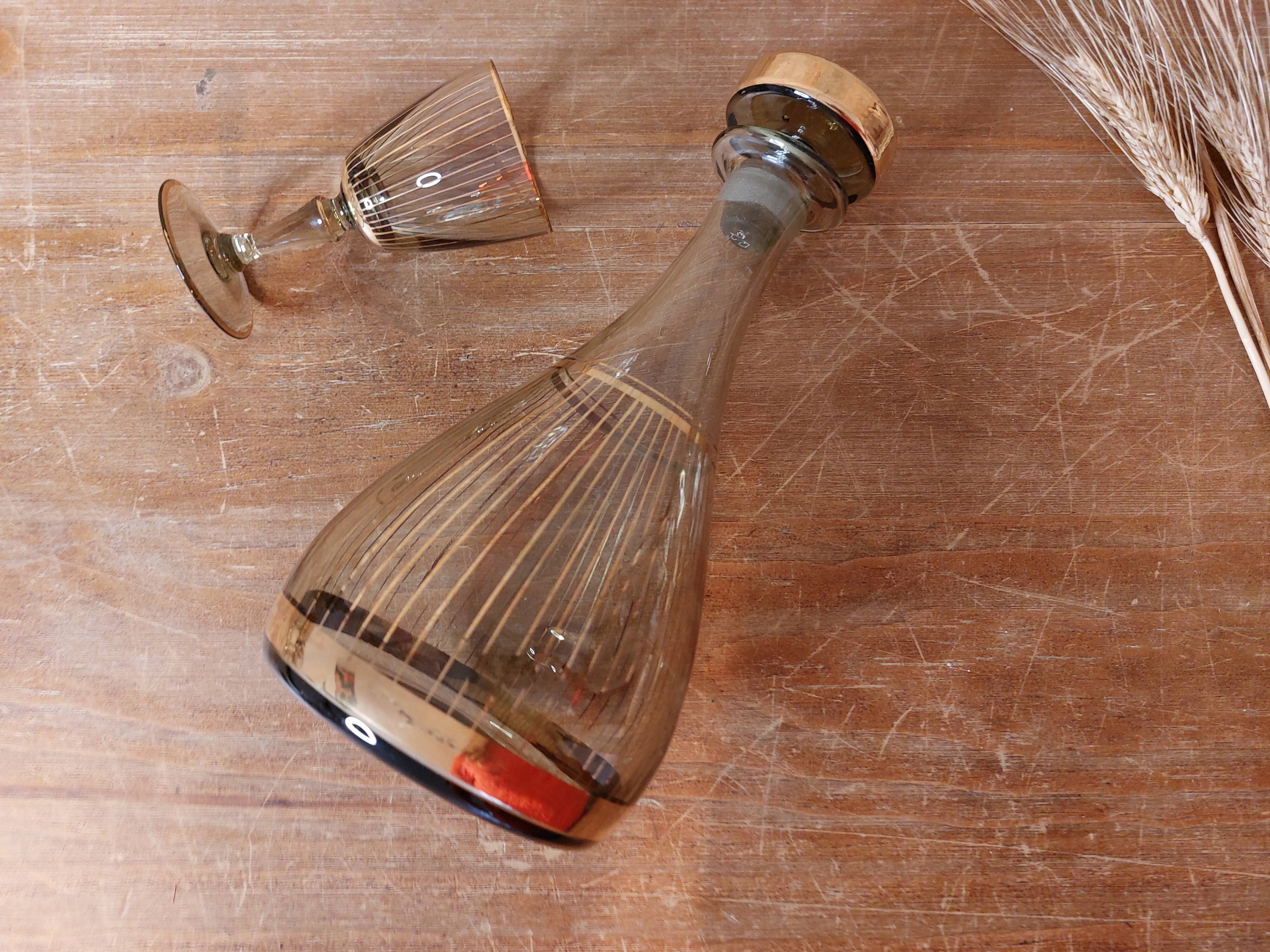 Vintage liqueur service, carafe and 7 amber brown glasses with gold edging