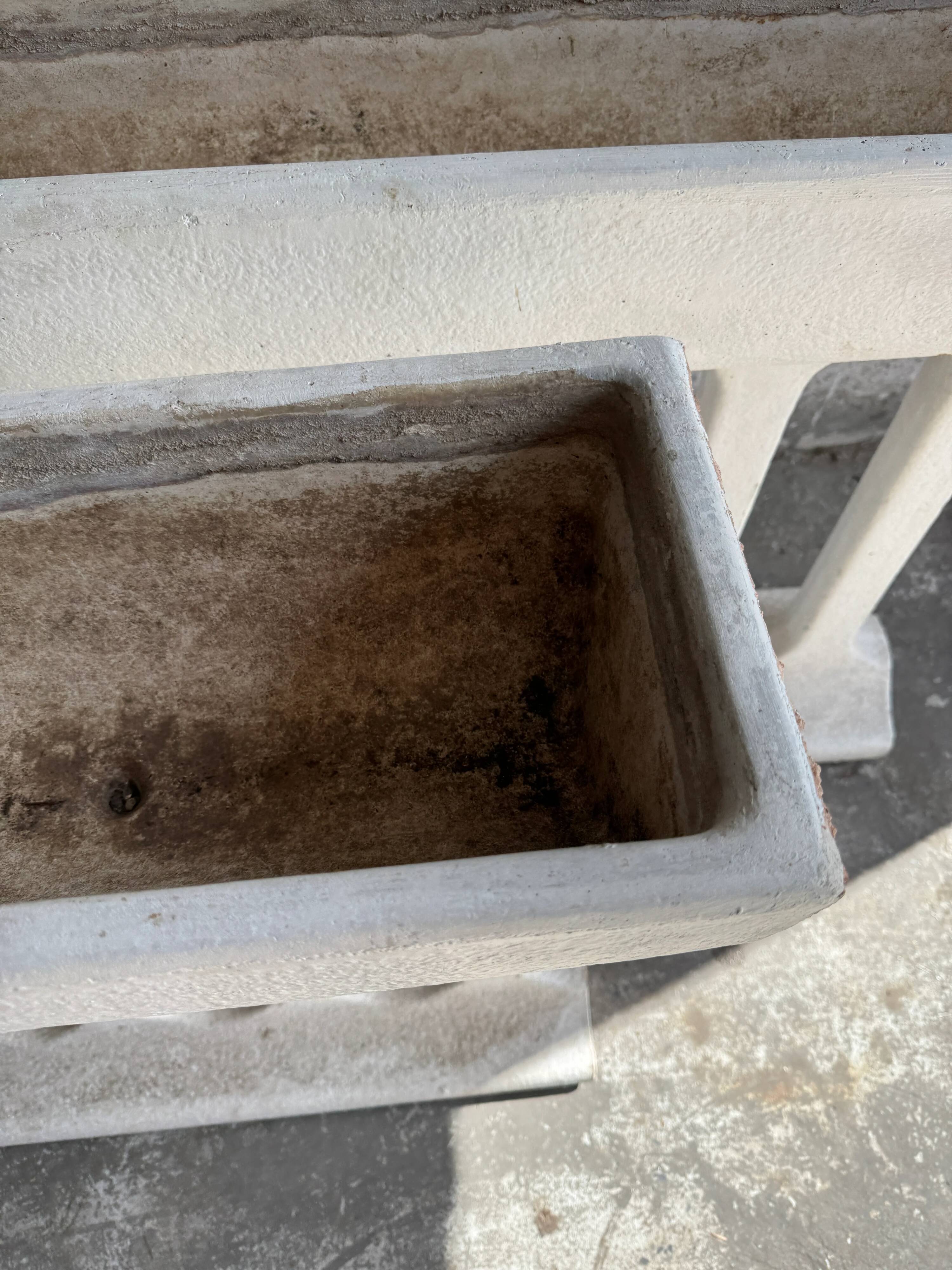 Pair of sculptural cast concrete planters in Off-White, mid-century brutalist style, long and rectangular.