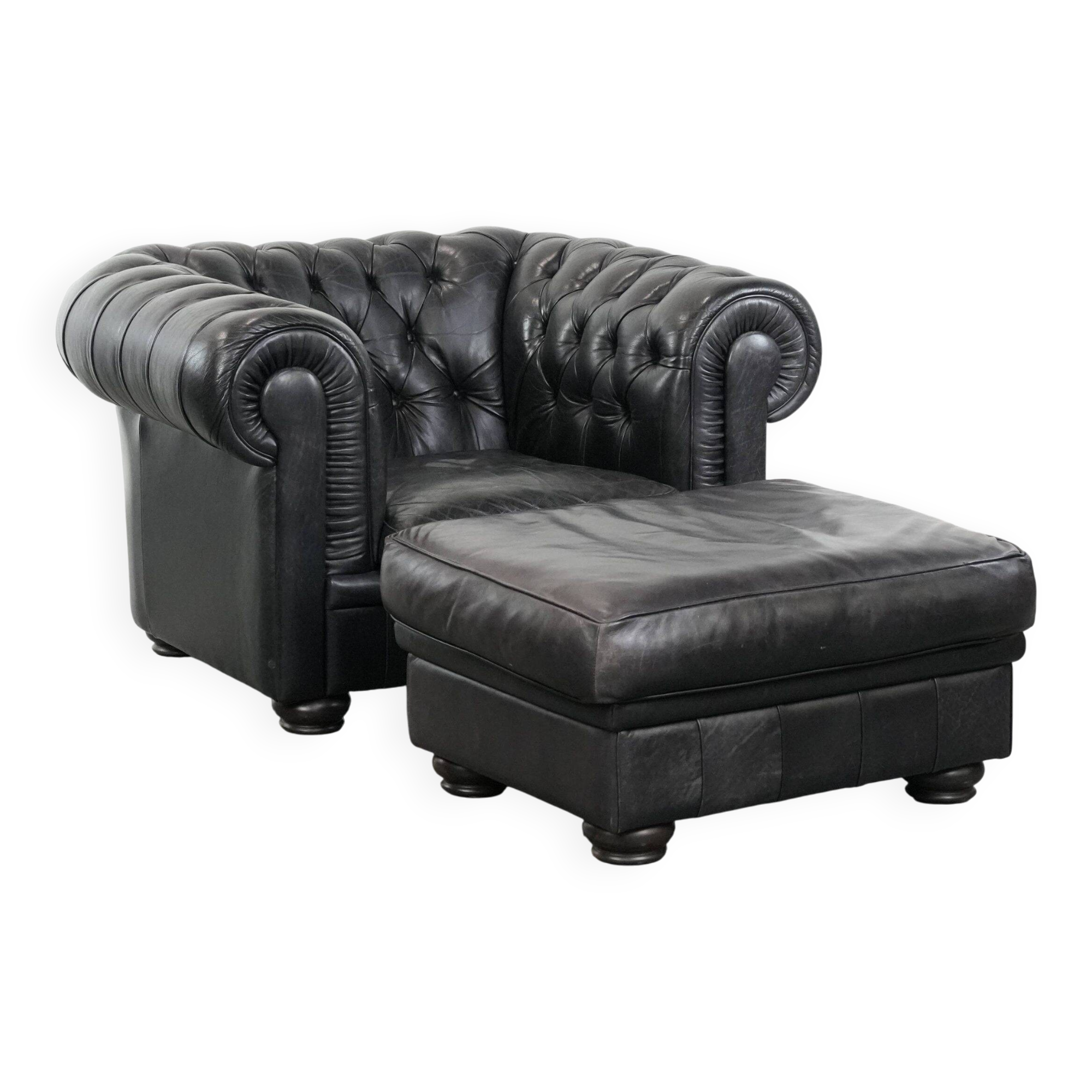 Set of a black cowhide leather Chesterfield armchair and matching ottoman