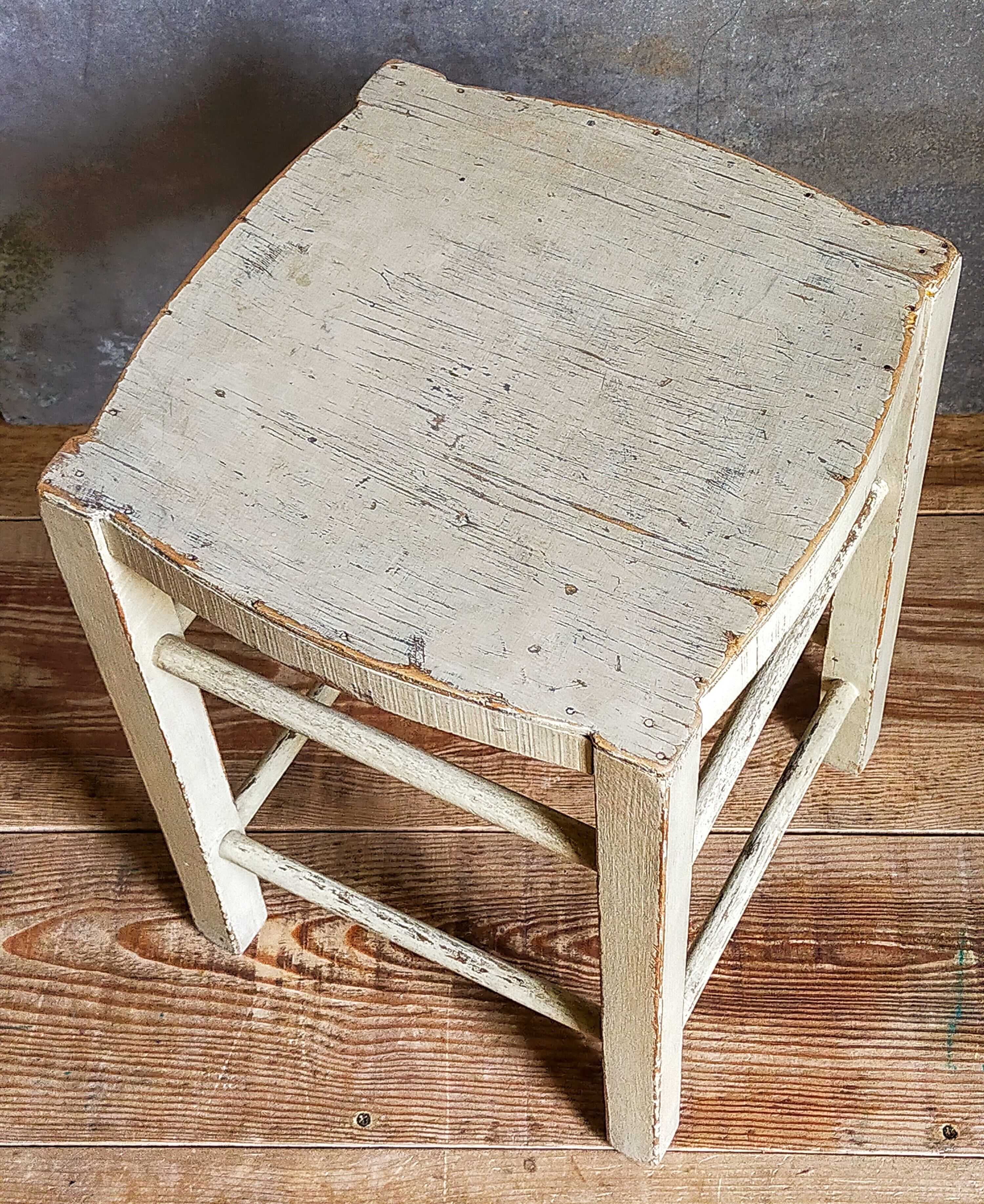 Old patinated painted wooden stool