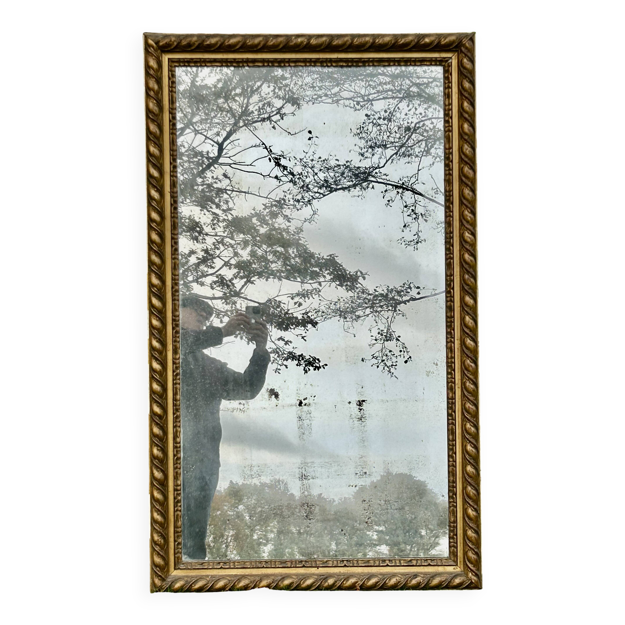 Large antique gilded mirror, wood and stucco gadroons, partially de-mercury