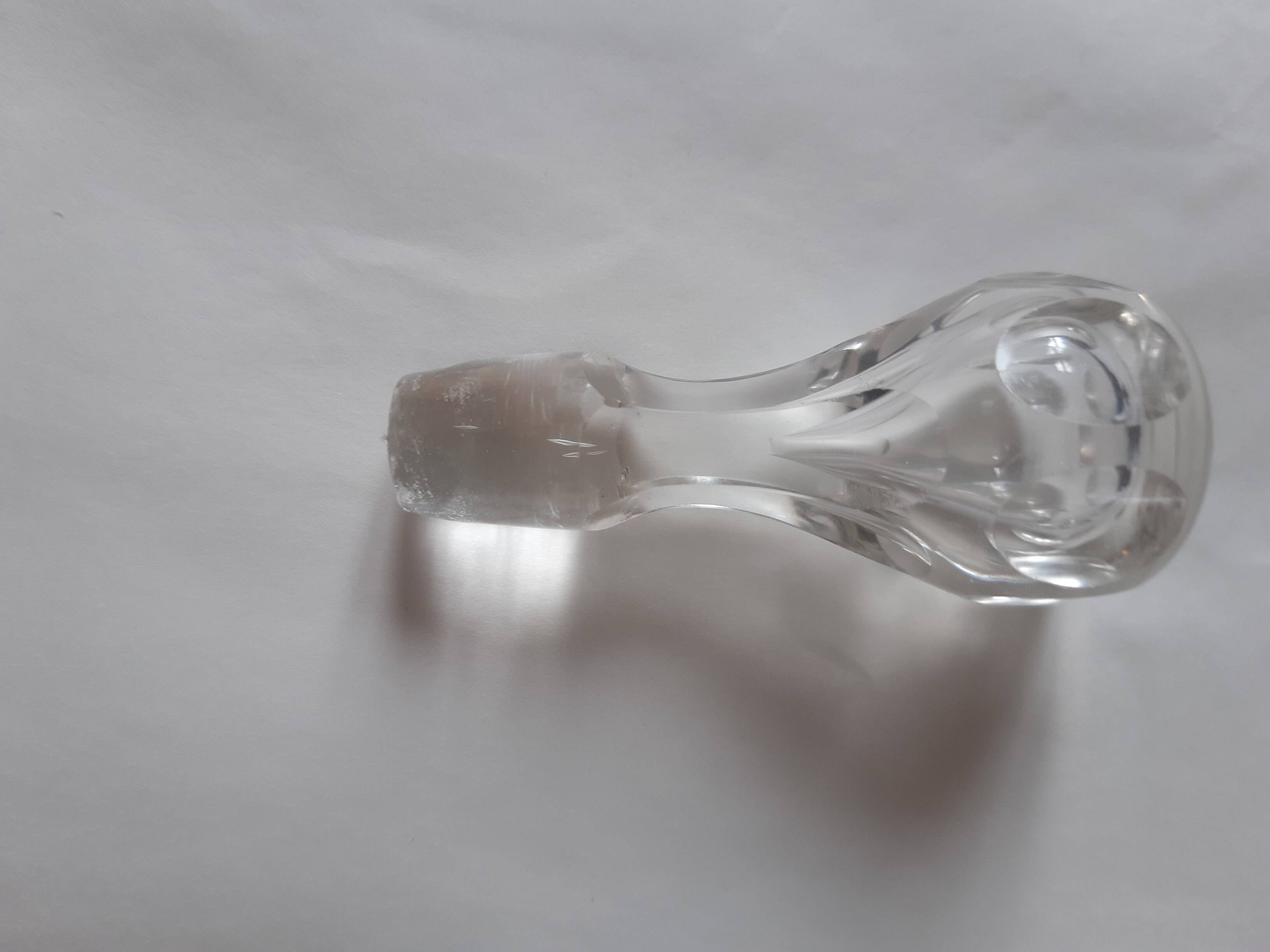 Cut crystal oil bottle with its crystal stopper.